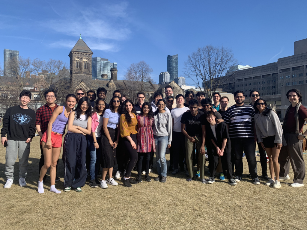 A group of students from the 2023/2024 MScAC cohort enjoying the weather on the University of Toronto campus.