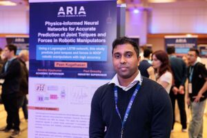 Master of Science in Applied Computing student Paan Kugathasan stands next to his research poster at the 2024 Applied Research in Action (ARIA) showcase. 