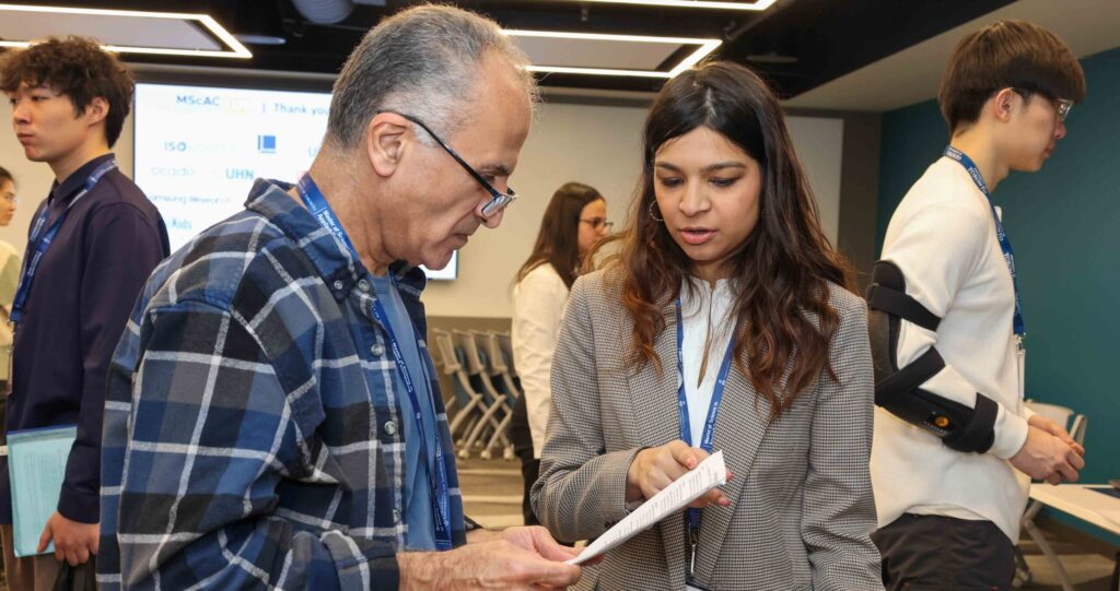 MScAC student discussing her resume with an industry partner.